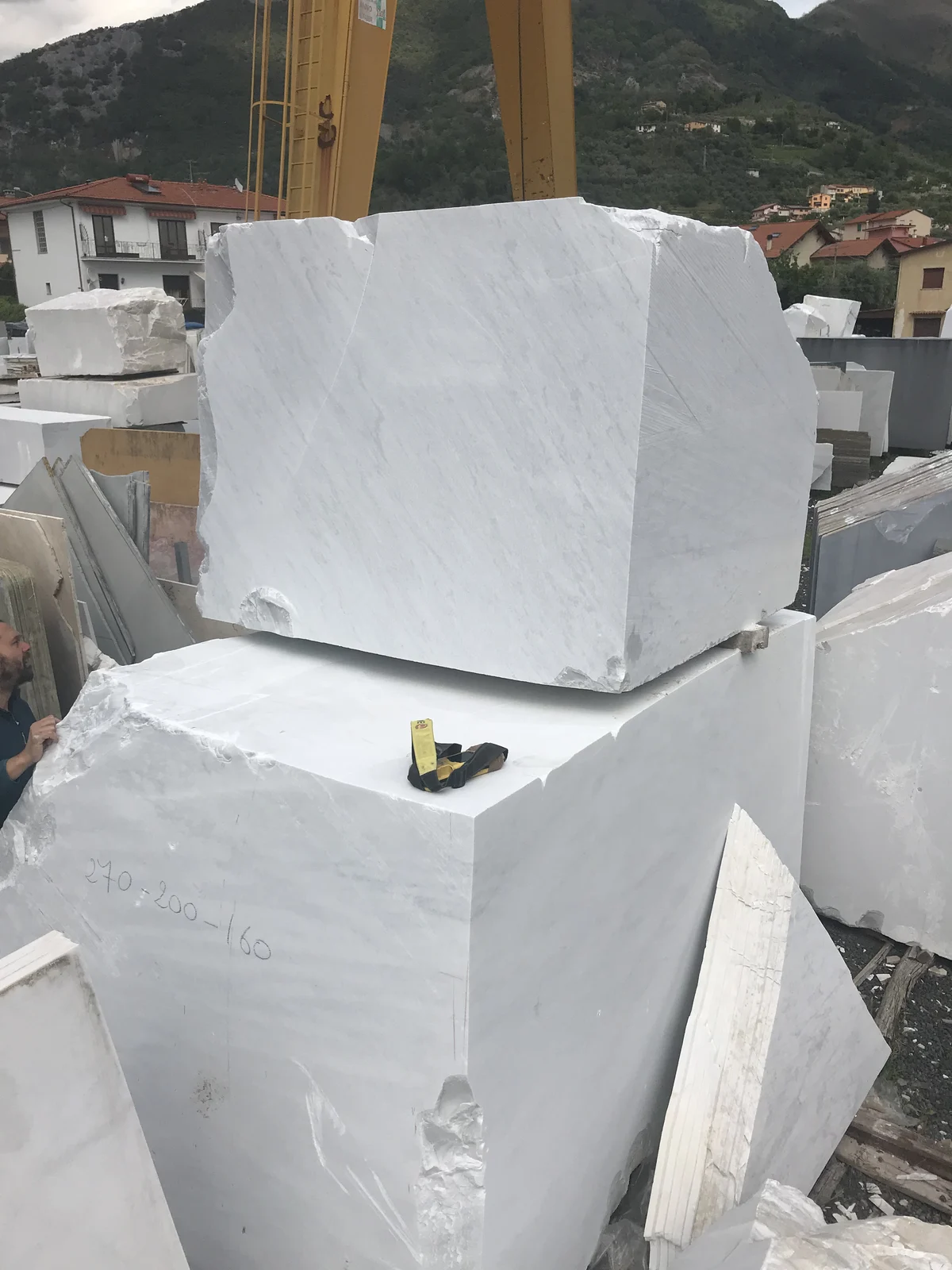 Large white marble blocks in a stone yard in Pietrasanta